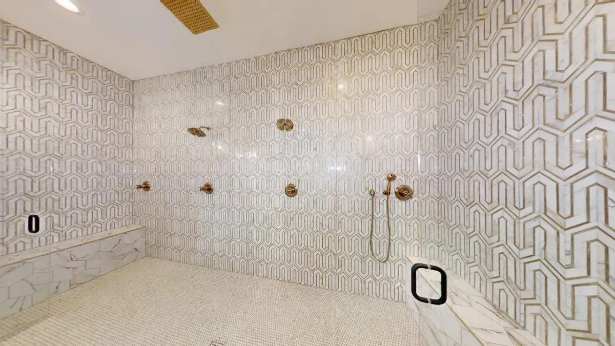 Extremaly large shower enclosed in seamless glass design.