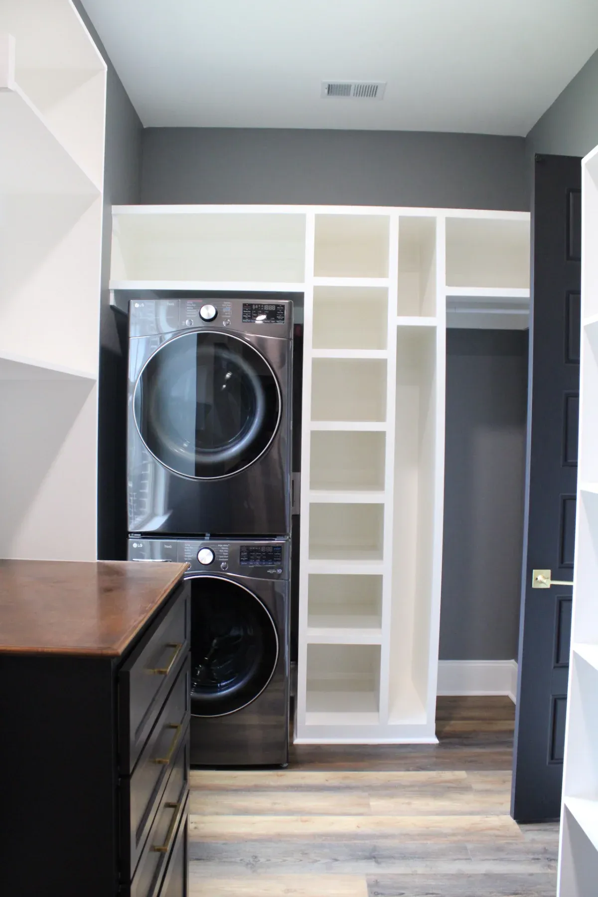 Laundry room featuring extra storage space.