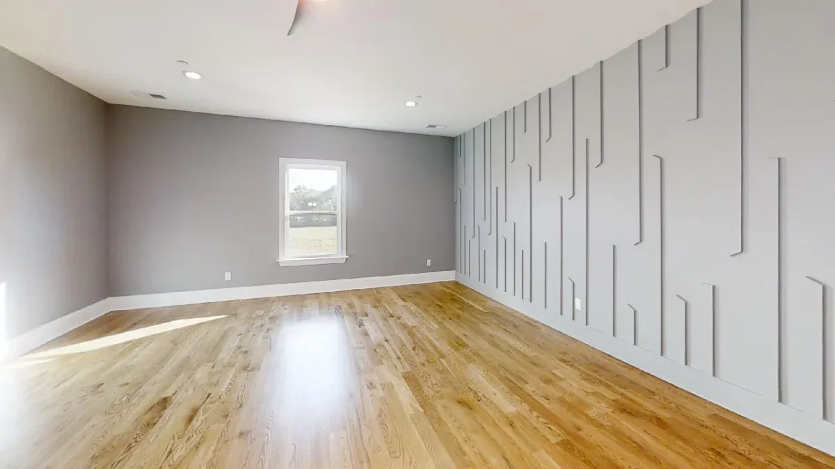 Bonus room featuing a modern wall design and wood floors.
